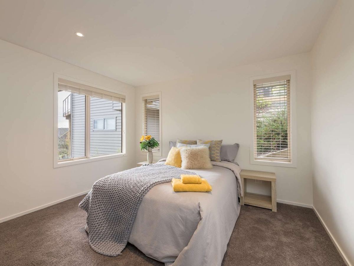 Staged bedroom with grey and yellow linen