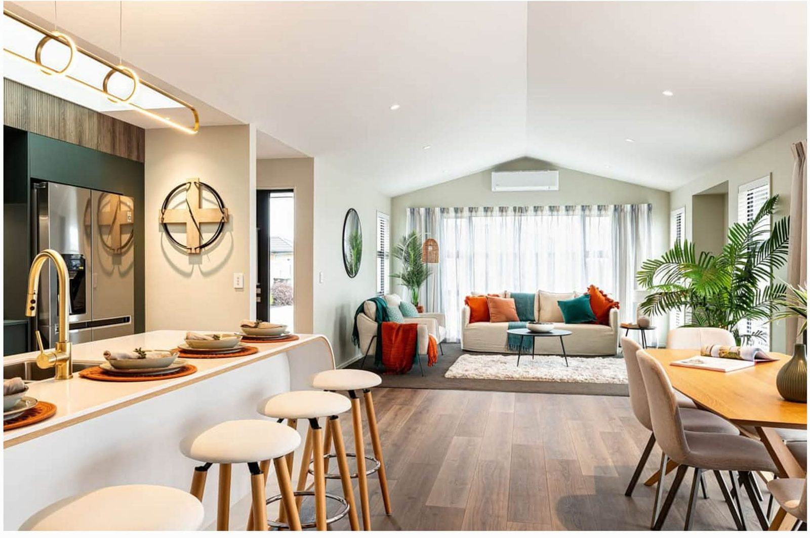A staged open-plan kitchen, dining and living area, styled and ready for sale