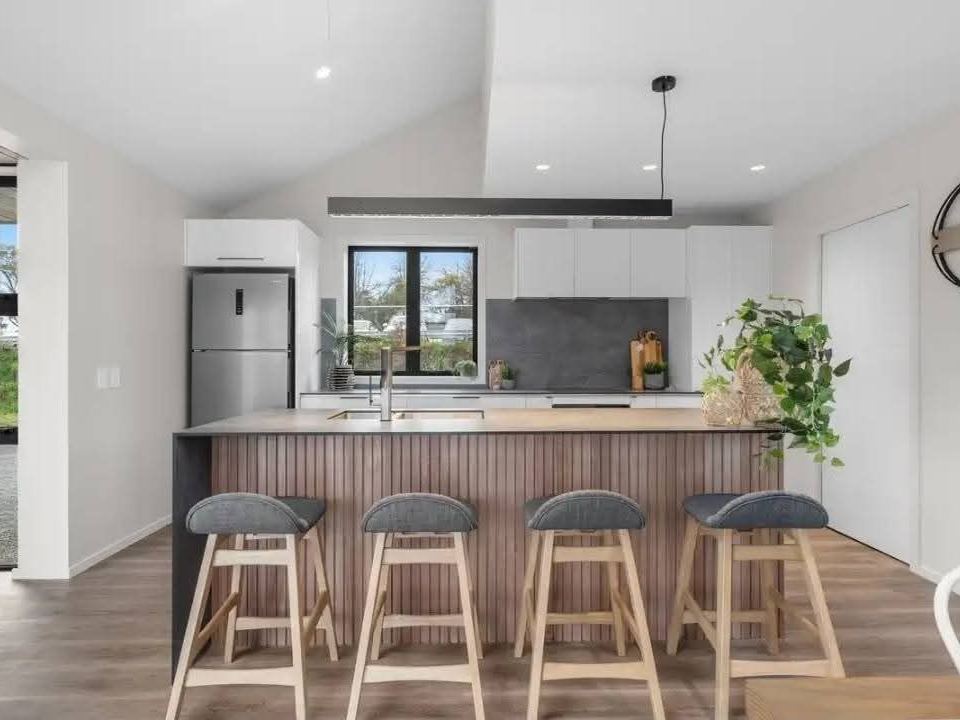 Staged kitchen with timber breakfast bar and stools